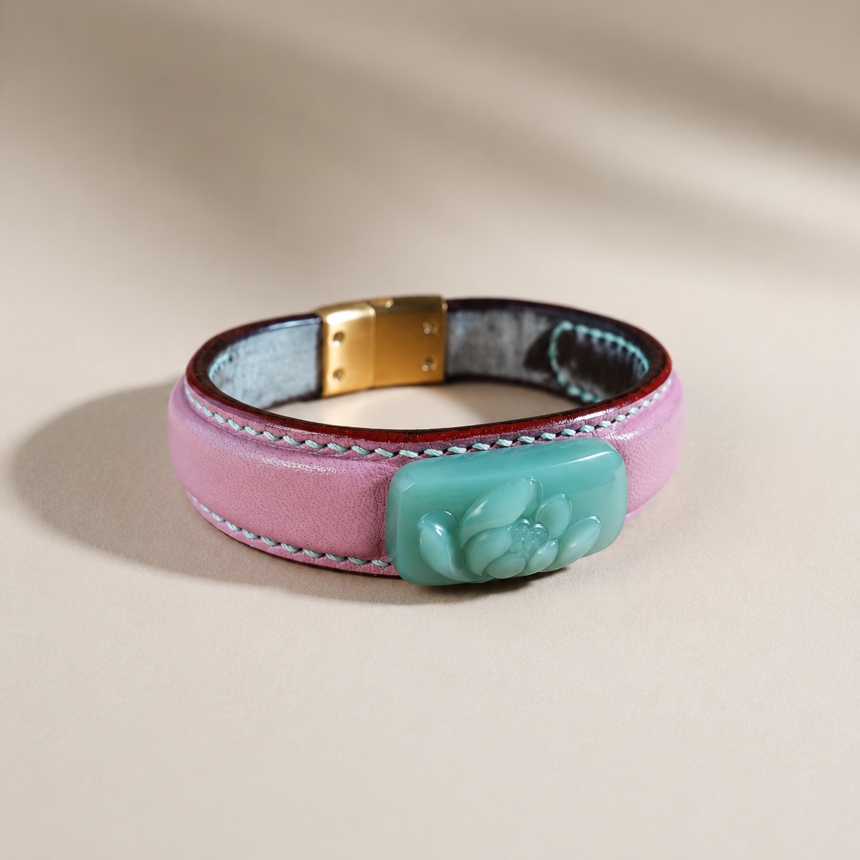 Blush and celadon lotus jade leather bracelet worn on wrist